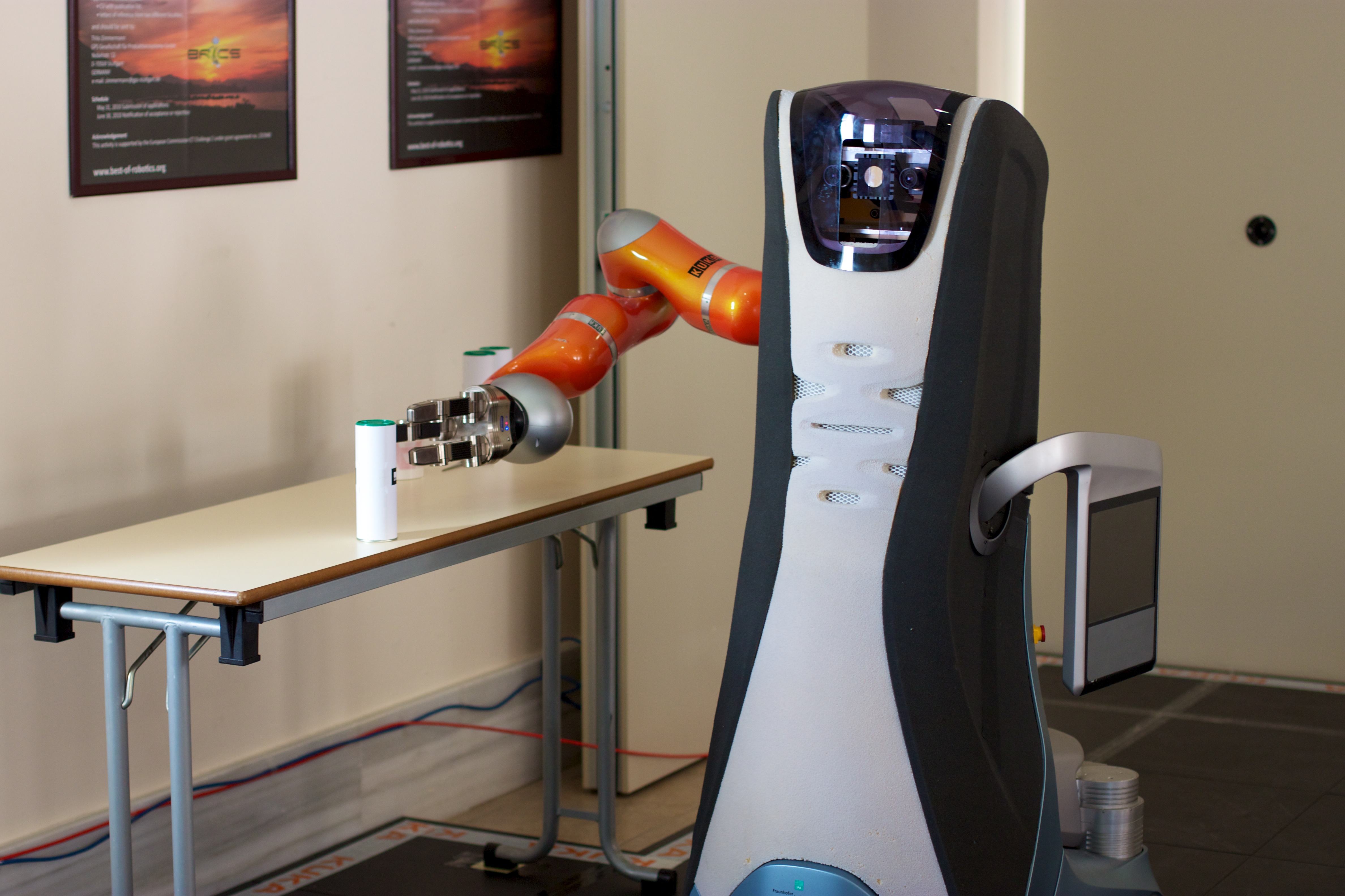 Service robot grasping an object on a table.