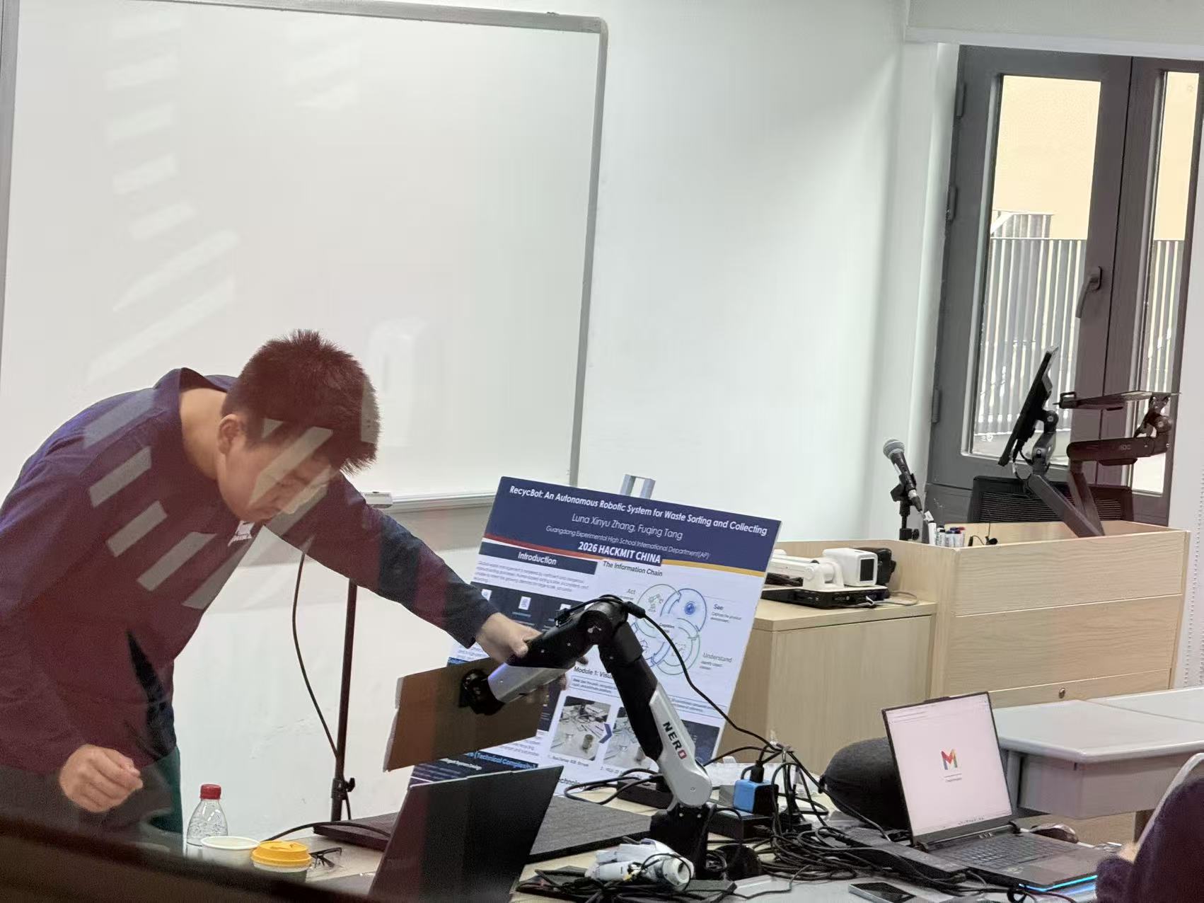 Team member positioning the calibration board with the robot for workspace alignment.